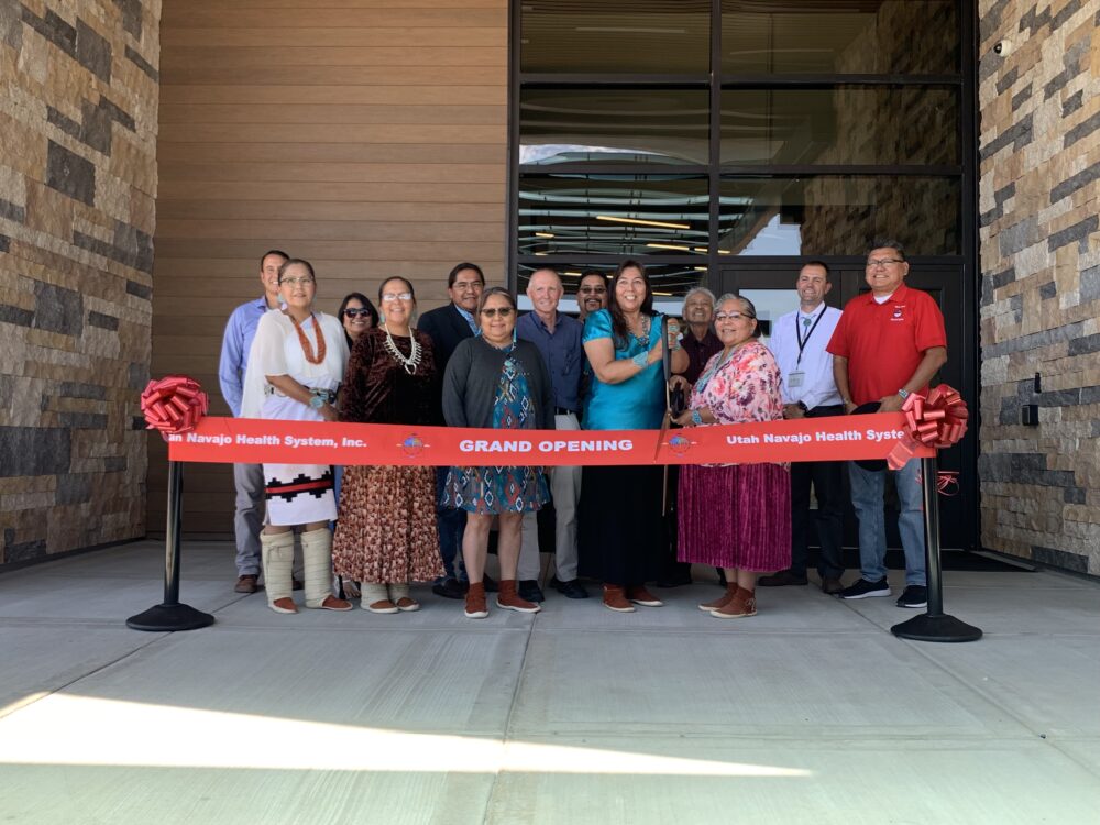 Board members and UNHS leadership gather for the ribbon cutting ceremony